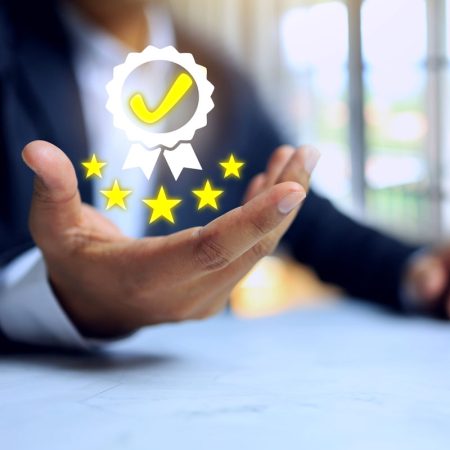 Certification concept with businessman holding quality assurance certified mark  to approved a standard or passed audit requirement according to industry regulations